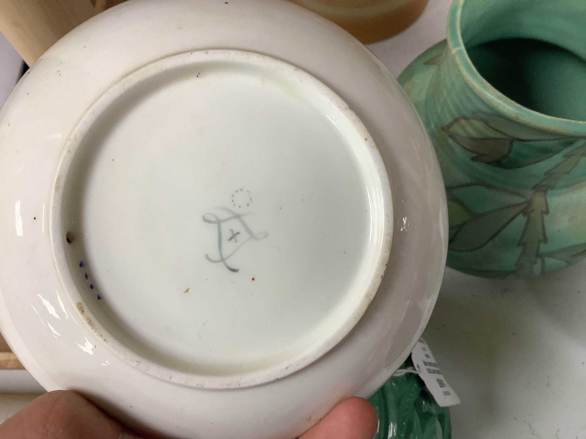 A Sevres porcelain coffee cup and saucer painted with flowers and chains of husks, and a paris porcelain plate with titled scene and initials TH